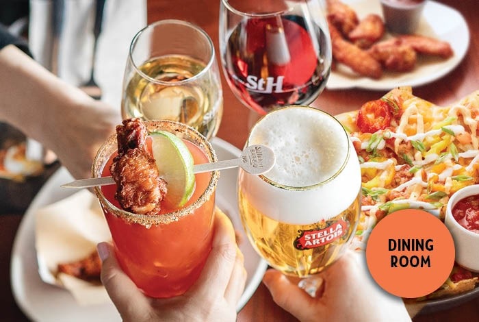 Zoom on 4 drinks being raised at a table