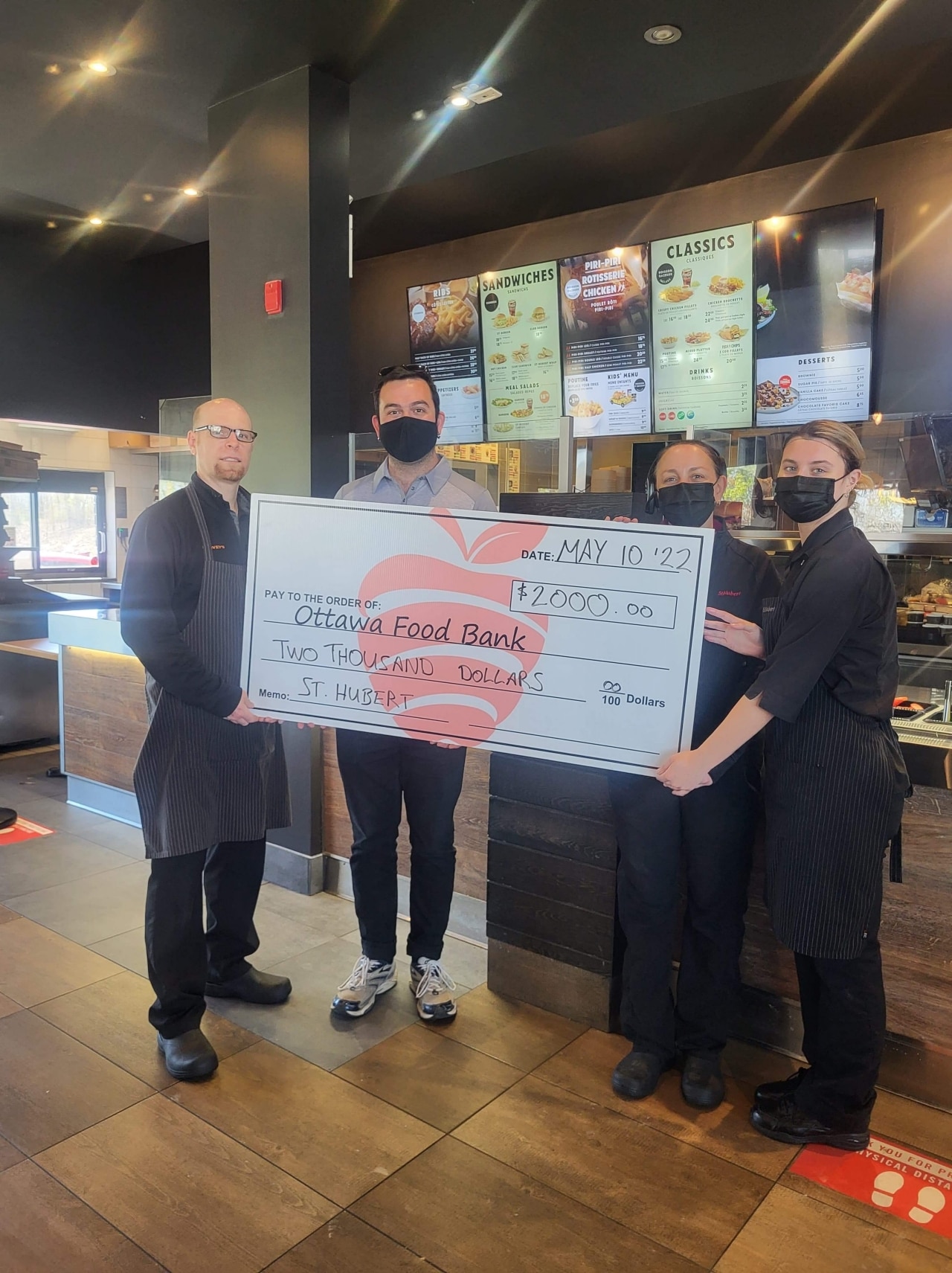 Group of people holding a check for the Ottawa Food Bank