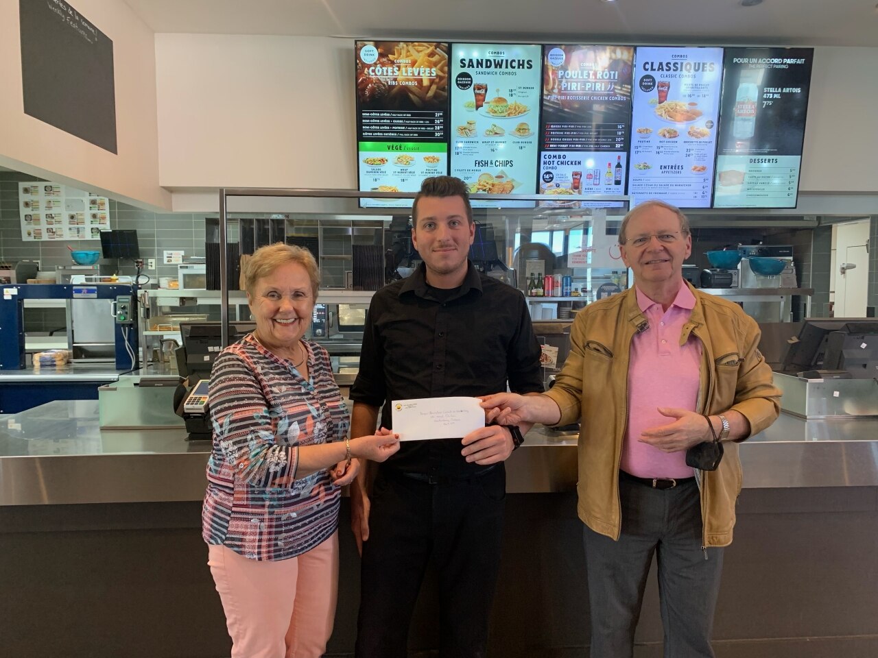 Group of people holding a check for the Hawkesbury Central Food Bank from the Hawkesbury