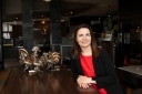 The owner sitting at the counter of her restaurant